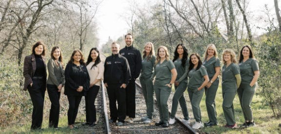 Back office staff standing in front of the building